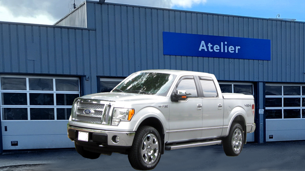 FORD150 In front of a 3 door Garage